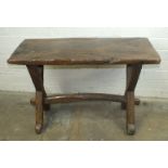 An antique Spanish rustic table, the single plank top on adzed X-frames and stretcher, 106 x 47cm.