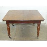 A 19th century pull-out extending dining table, the top with moulded edge on turned legs, 114 x