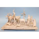 An interesting 19th century carved marine ivory diorama group, comprising an Eskimo family on sled