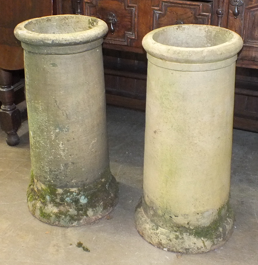 A pair of earthen ware chimney pots, 62cm high.