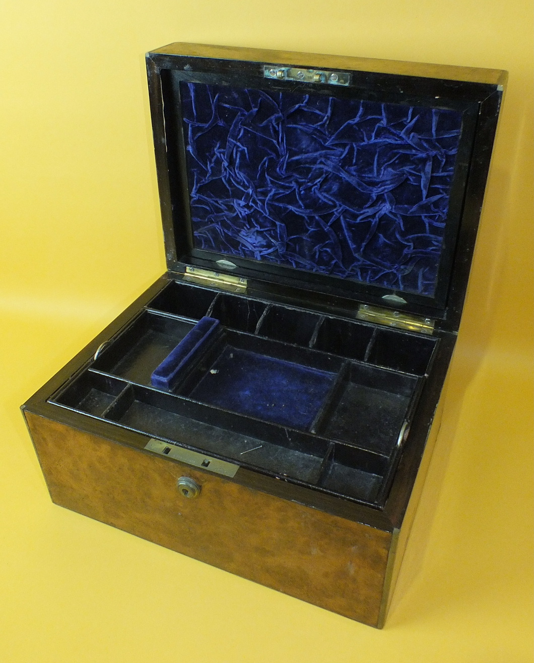 A late-Victorian brass-bound burr walnut jewellery box with hinged lid opening to reveal an interior