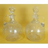 A pair of 19th century bulbous cut glass wine jugs, the body etched with flowers and leaves, with