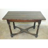 An antique oak sidetable, the planked top above a plain frieze, on turned legs joined by shaped