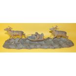 A Scandinavian carved wood figure group of a figure and a sleigh pulled by a reindeer, with