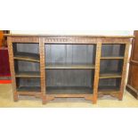 A 20th century carved oak open breakfront bookcase, 182cm wide, 104cm high.