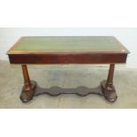 A mahogany centre table with inset leather writing surface, above two drawers on turned columns