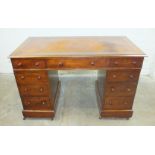 A 19th century mahogany knee-hole writing desk, the rectangular top above an arrangement of three