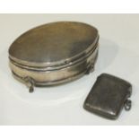A silver trinket box of elliptical shape raised on four pad feet, 8cm long, Birmingham 1905 and a
