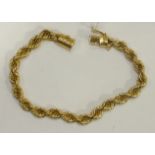 A yellow gold rope link chain bracelet, marked 750, 13.5g.