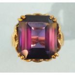 A 9ct gold ring set large purple/red synthetic corundum, size L, 10.7g.