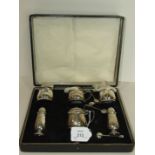 A six-piece silver cruet set with spoons, cased, Birmingham 18376/7___6oz.