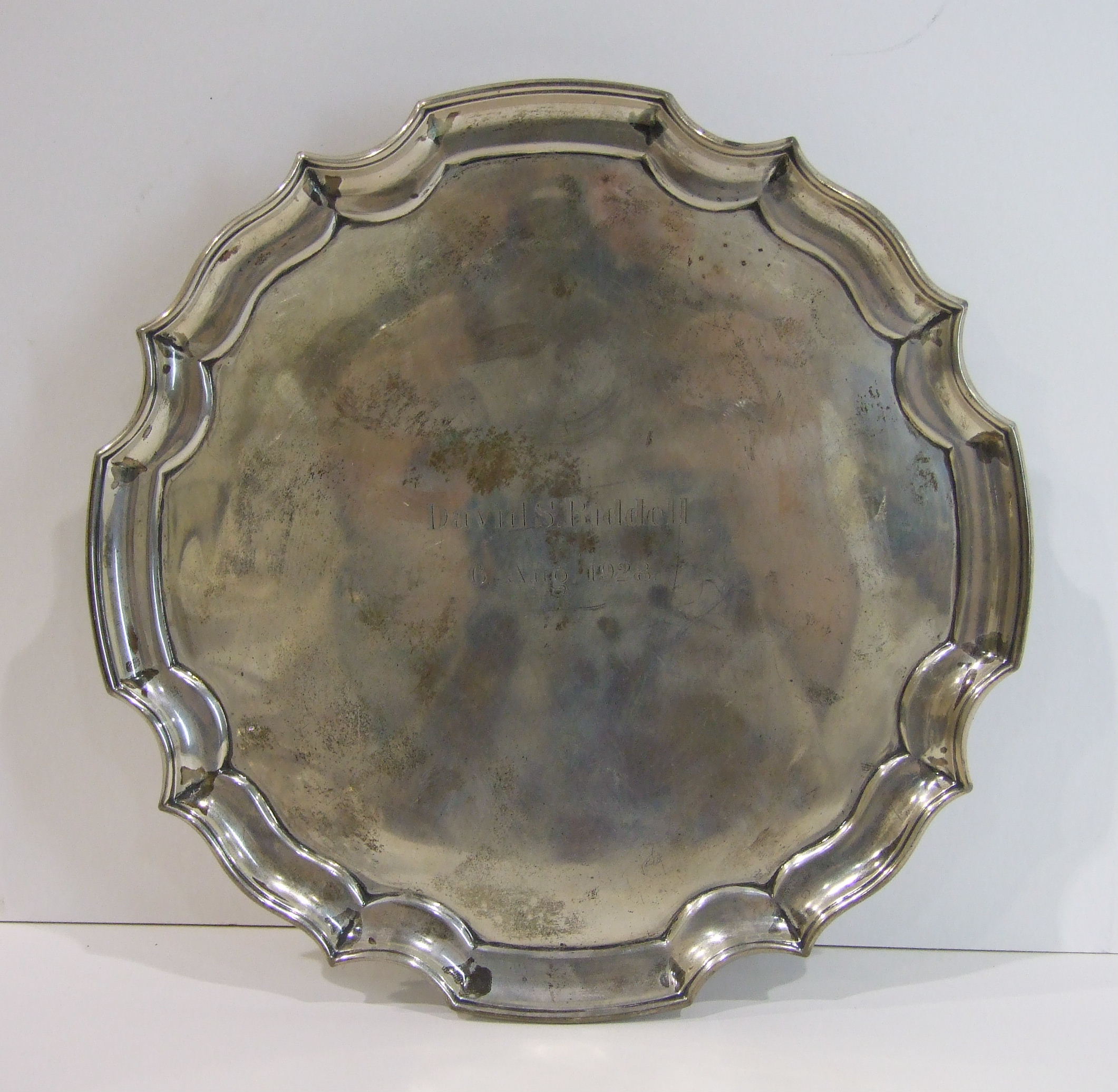 A silver card tray with Chippendale border on three scroll feet, Sheffield 1951, 20.5cm