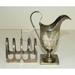 A late Victorian silver helmet shaped cream jug on square base, Birmingham 1894 and a small siver