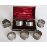 A cased pair of engraved silver napkin rings, Sheffield 1909, a silver napkin ring by Christopher