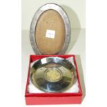 An oval silver photograph frame, 16 x 11cm, Birmingham 1919 and a commemorative pin tray, Birmingham