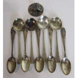 Five silver teaspoons, four silver coffee spoons and a 925 silver miniature model of a violinist