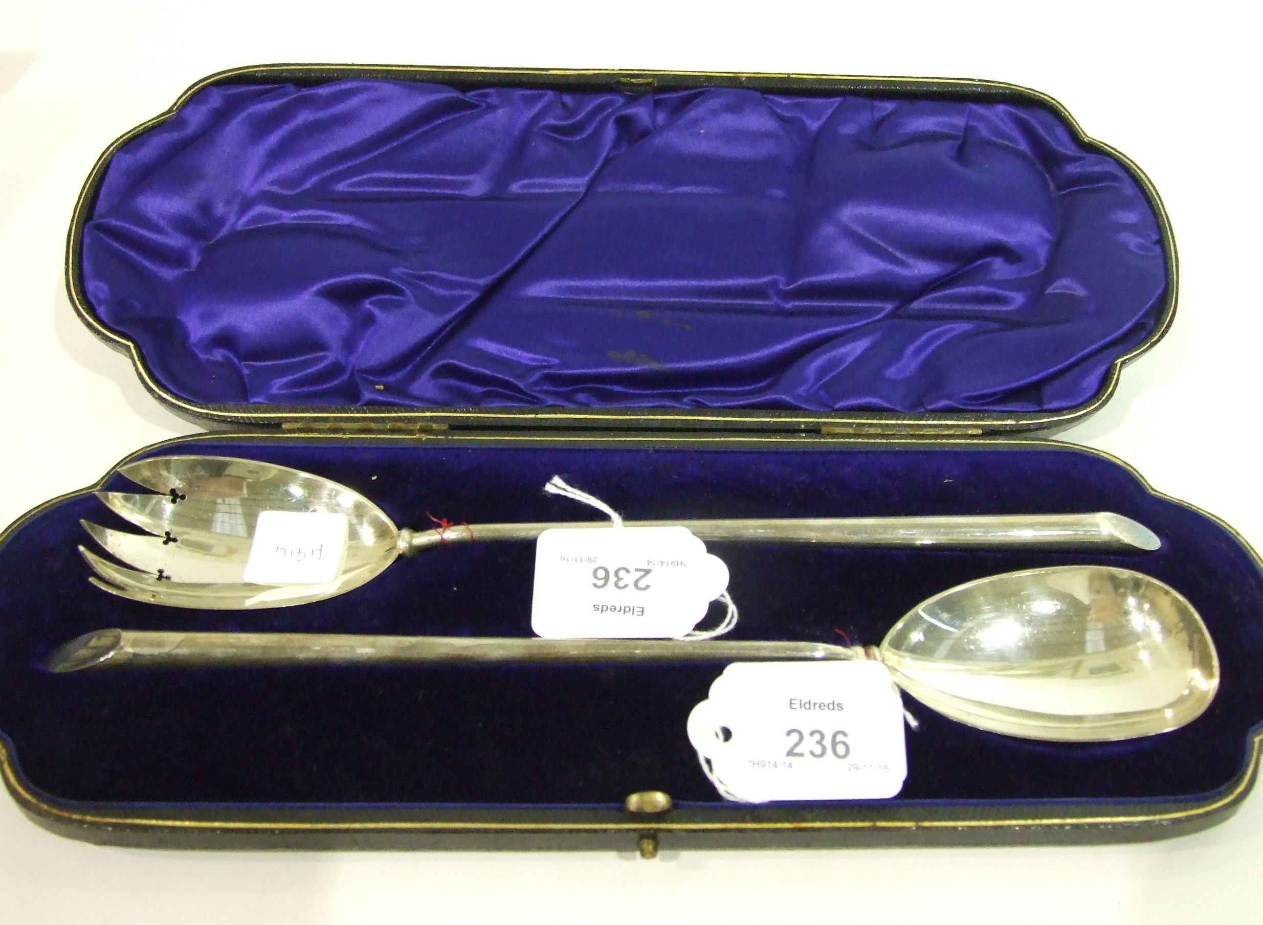 A cased pair of late Victorian silver salad servers of plain form by William Hutton & Sons Ltd,