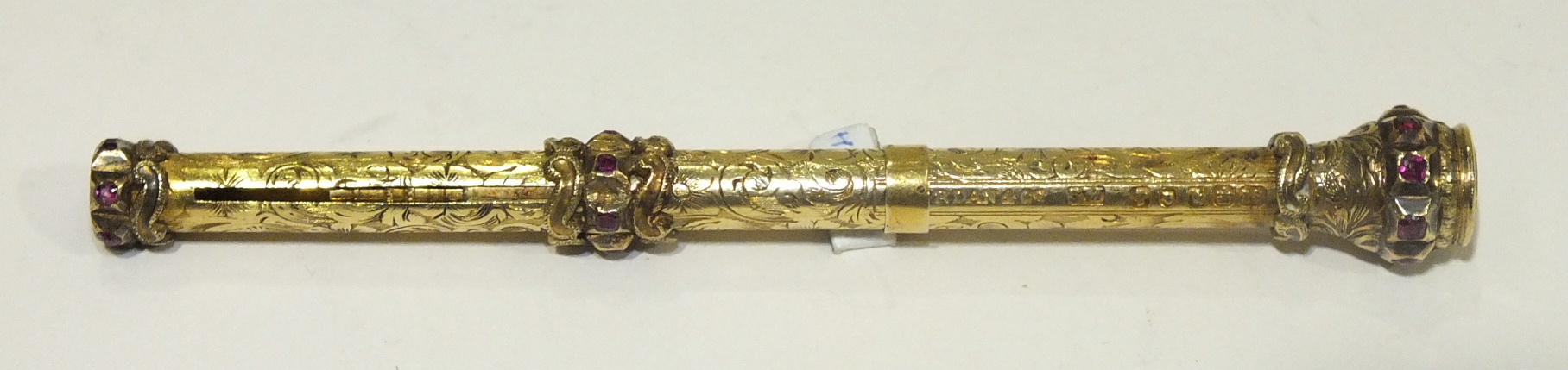 Sampson Mordan & Co, a Victorian 18ct gold propelling pencil with scroll engraved barrel and ruby