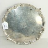 A silver salver with reeded Chippendale border, on four pad feet, maker Edward Barnard & Son Ltd,