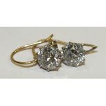 A pair of diamond drop earrings, each claw set a brilliant cut diamond of approximately 0.9cts in