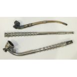 An Eastern white metal covered opium pipe, 44cm long and another small metal pipe, (2).