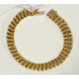 A chain bracelet of plain and textured links, marked 750, 26g.