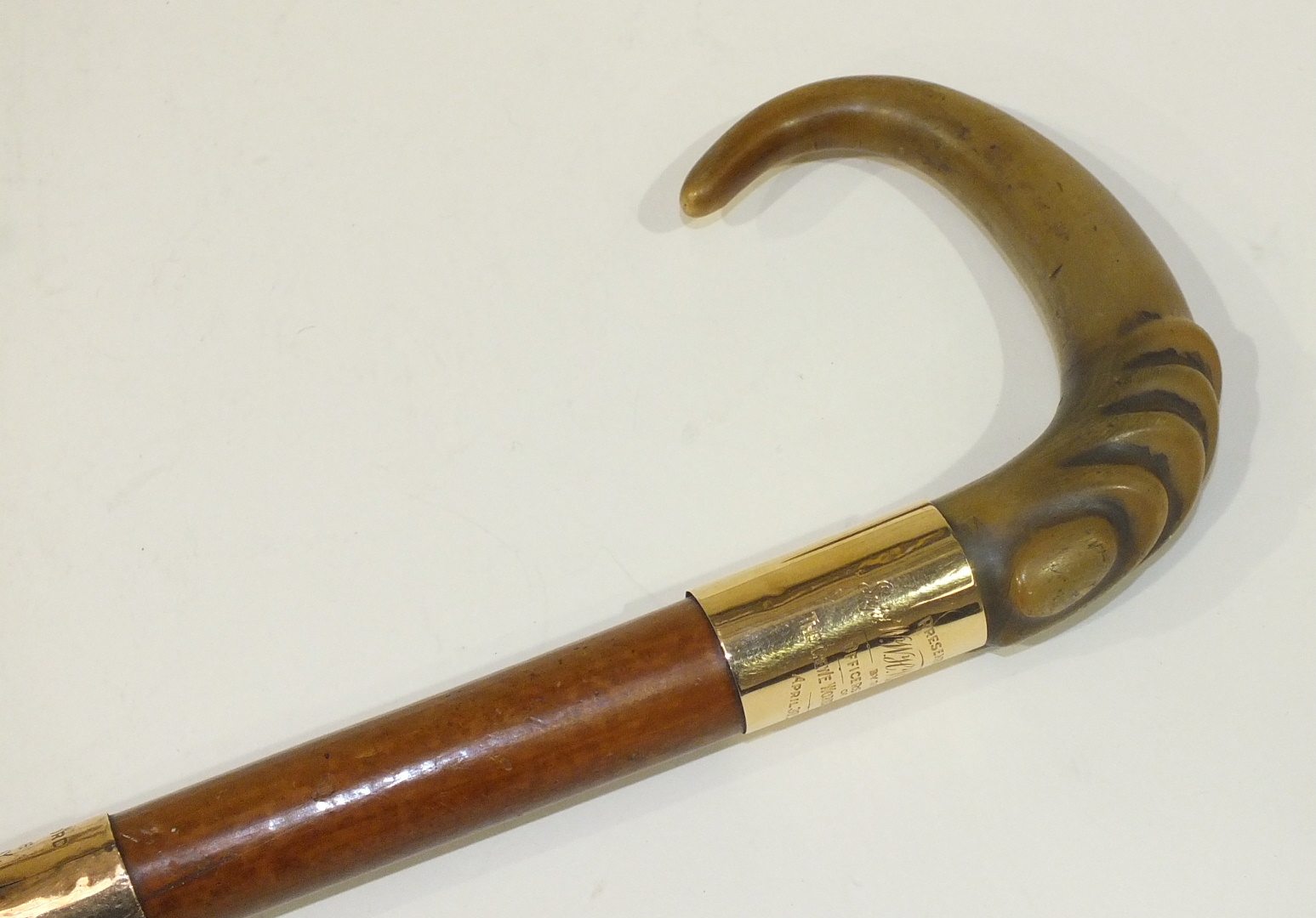 A horn-handled walking stick with yellow metal mounts, inscribed Presented to Supt WWH Warneford