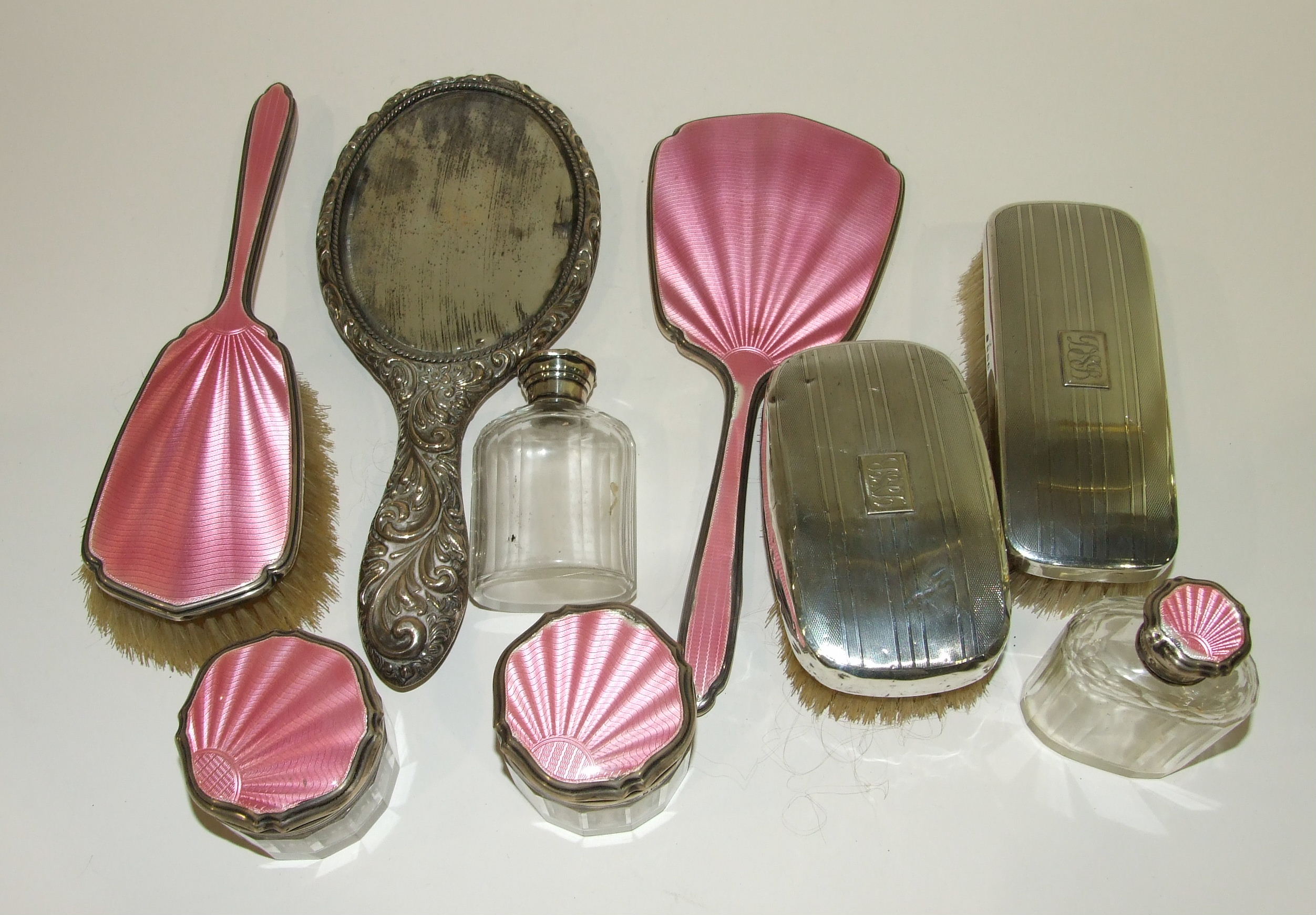 A six-piece silver and pink guilloche enamel dressing table set : brush, mirror and four glass