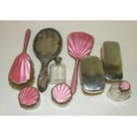 A six-piece silver and pink guilloche enamel dressing table set : brush, mirror and four glass