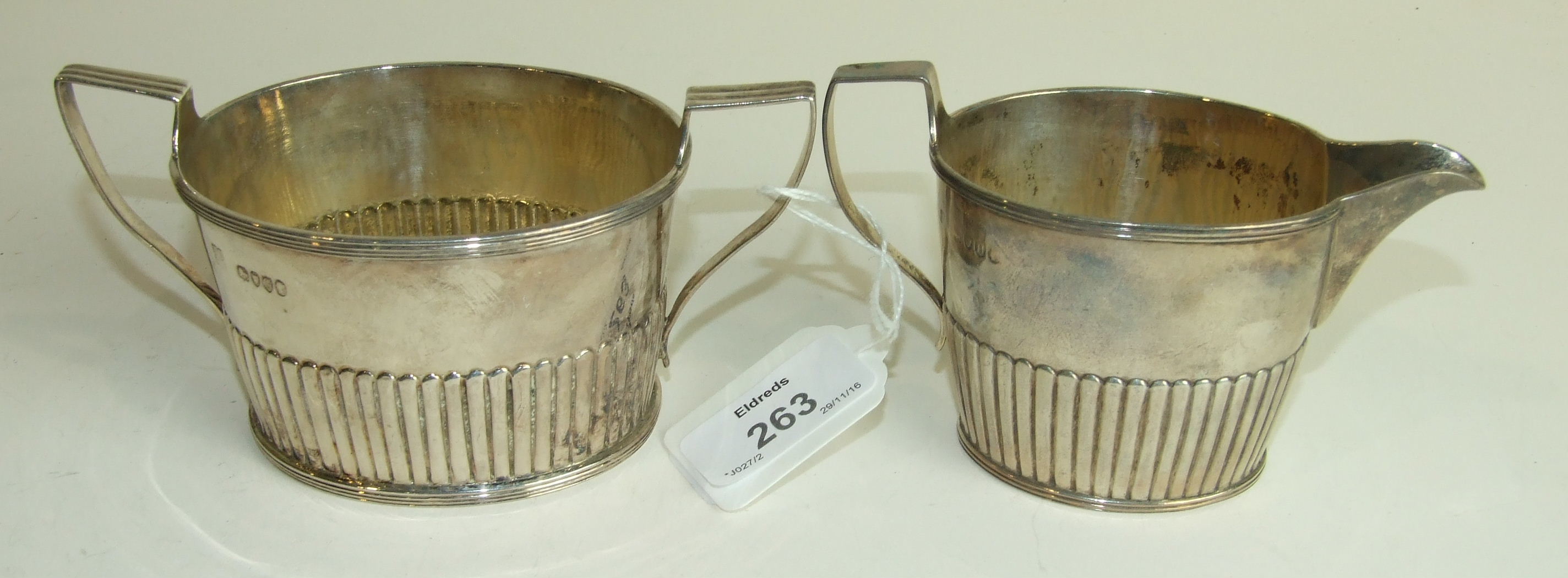 A Victorian silver sugar basin and cream jug of tapered half reeded form, London 1882/3___8.5oz.