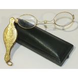 A pair of 18ct gold lorgnettes, the covers engraved with scrolls and vacant cartouche, bearing