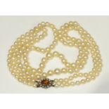 A necklace of two strings of graduated cultured pearls, 5mm-9mm with 9ct gold mounted citrine and