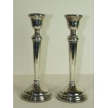 A pair of silver loaded candlesticks of tapered form on circular bases (af), Birmingham 1951, 30.5cm