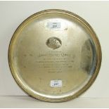 A silver circular salver with reeded rim on three scroll feet, with engraved "His Master's Voice"