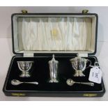 A cased three piece silver cruet set by Elkington & Co with one spoon and one associated spoon,