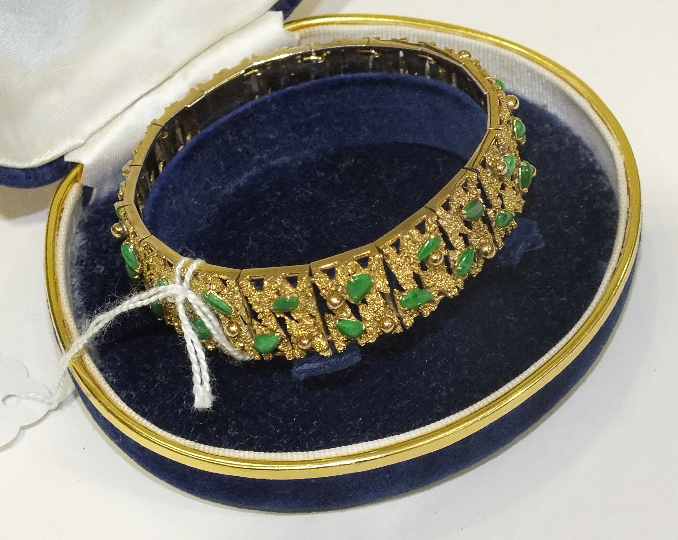 A 14k yellow gold bracelet of textured and pierced linked plaques, each set with two jade cabochons, - Image 2 of 2