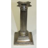 A silver Doric column candlestick with beaded base, Sheffield 1911, 18cm high.