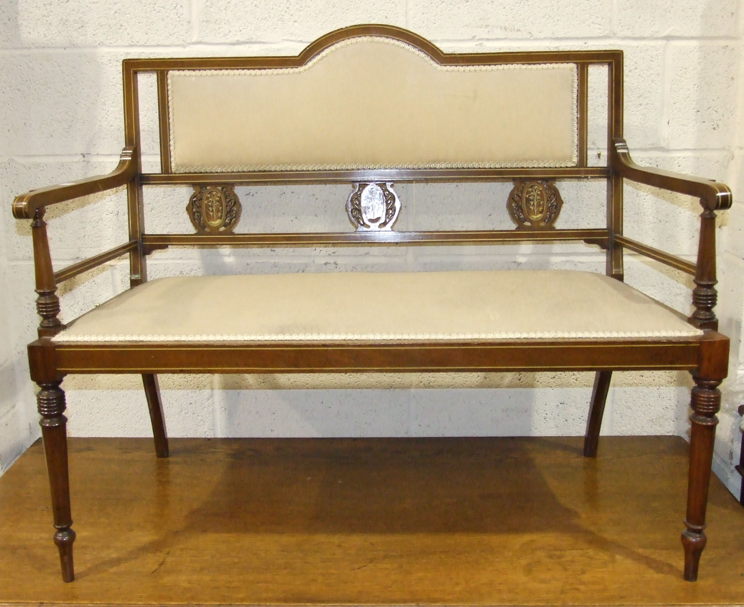 An Edwardian inlaid mahogany hall seat with partially padded back and seat, 109cm wide.