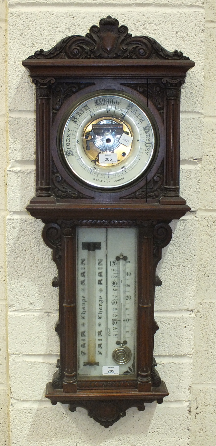 A Maple & Co. walnut aneroid barometer, the architectural form case with circular ceramic dial and