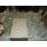 A collection of cut glass decanters, drinking glasses and bowls.