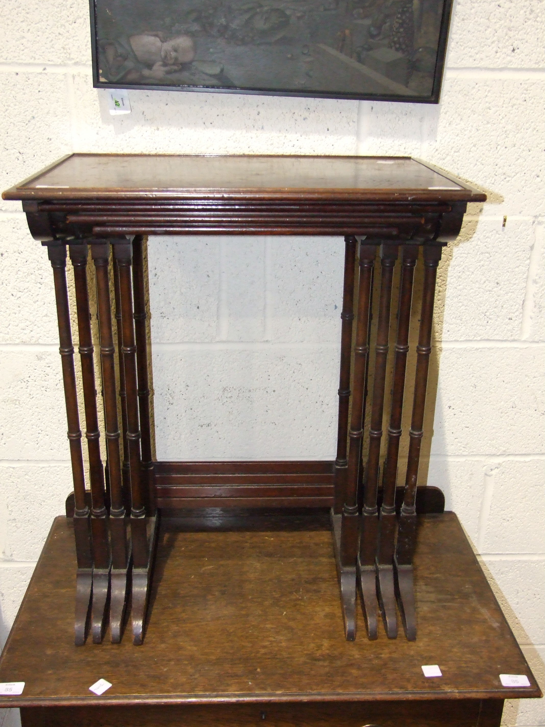 A nest of four Regency style mahogany rectangular top tables on turned legs, 56cm wide.