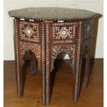 A Moorish octagonal table profusely inlaid with ebony and ivory, fitted with a drawer, 44cm wide,