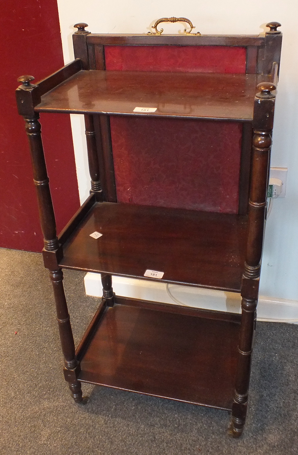 A George IV mahogany three-tier whatnot, the rectangular tiers and turned supports with rising