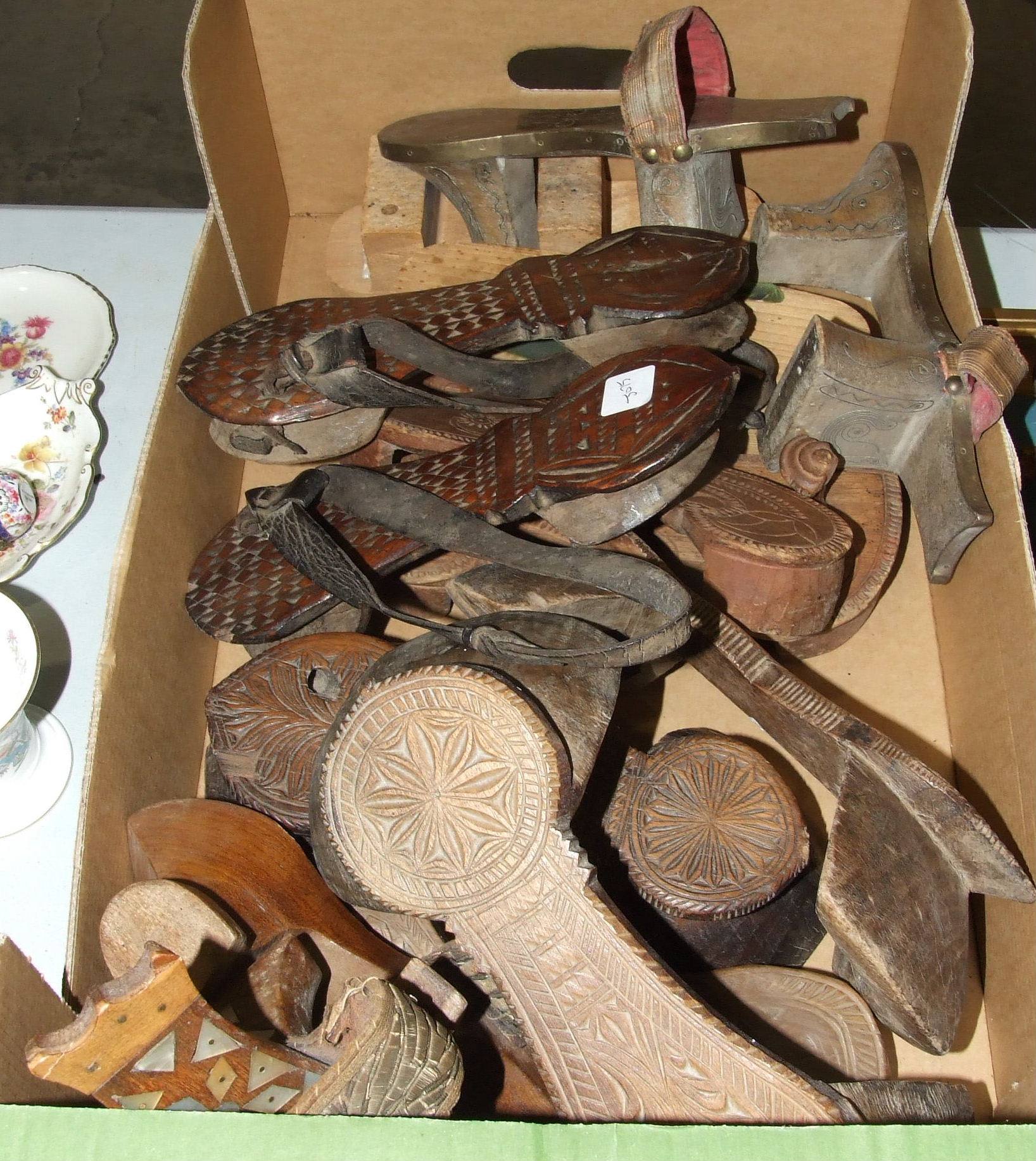 Six pairs of wood pattens and two small wall mirrors.