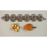 A silver mounted amber brooch in the form of a leaf, marked SBM, (af), a "Hollywood" white metal
