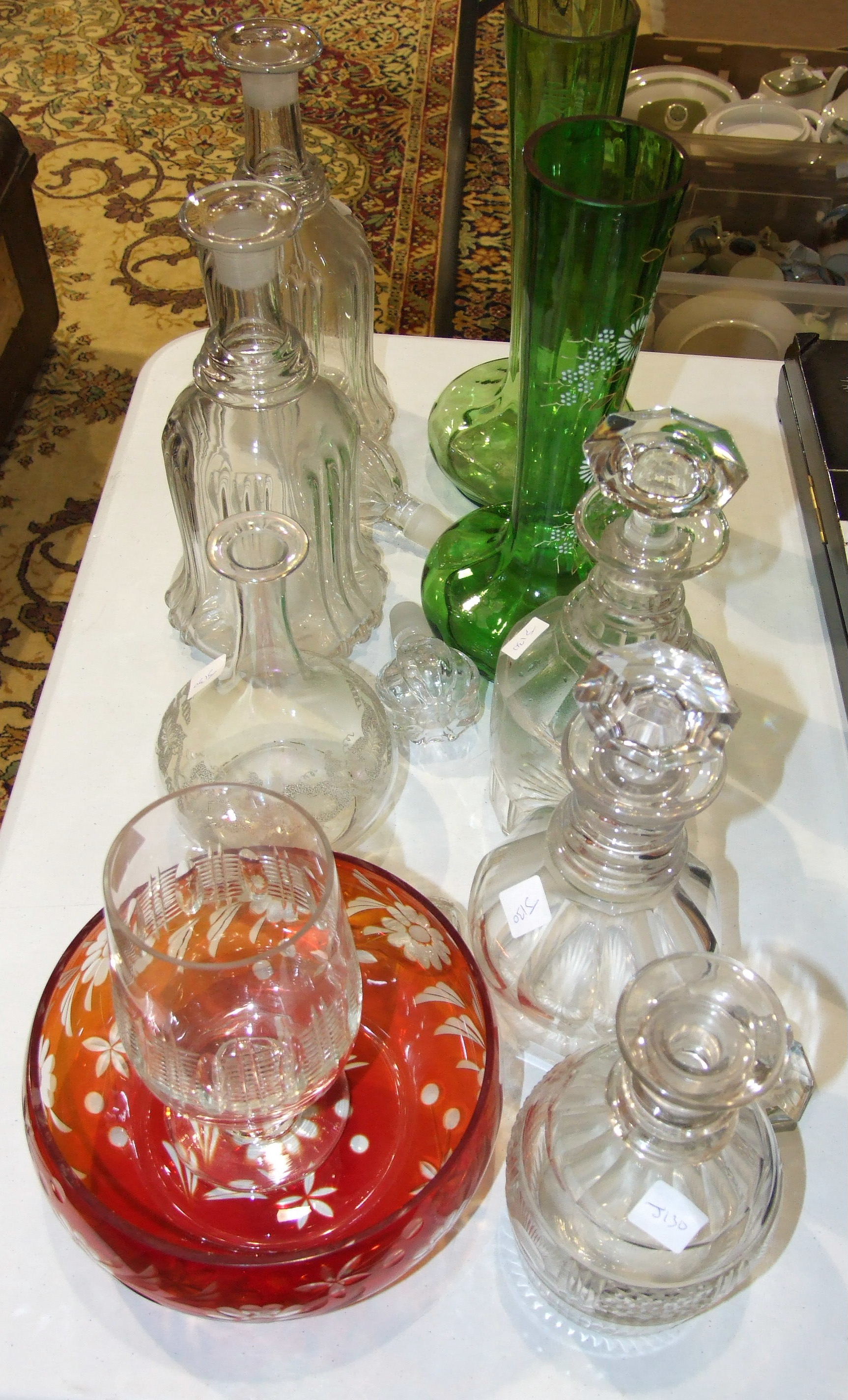 A pair of mallet shaped glass decanters with stoppers, 34cm high, three other decanters, a celery