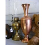 A vintage paraffin lamp together with a decorative urn.