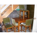 A retro extending dining table and four chairs