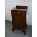 A quality mahogany and walnut bedside cabinet on paw feet