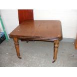 A Victorian mahogany dining table with extra leaf